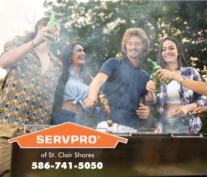 Happy people are seen barbecuing outdoors.