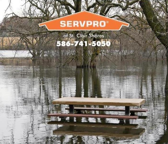 flooded river bank with picnic table 