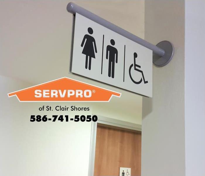 A sign for public restrooms is visible on a wall.